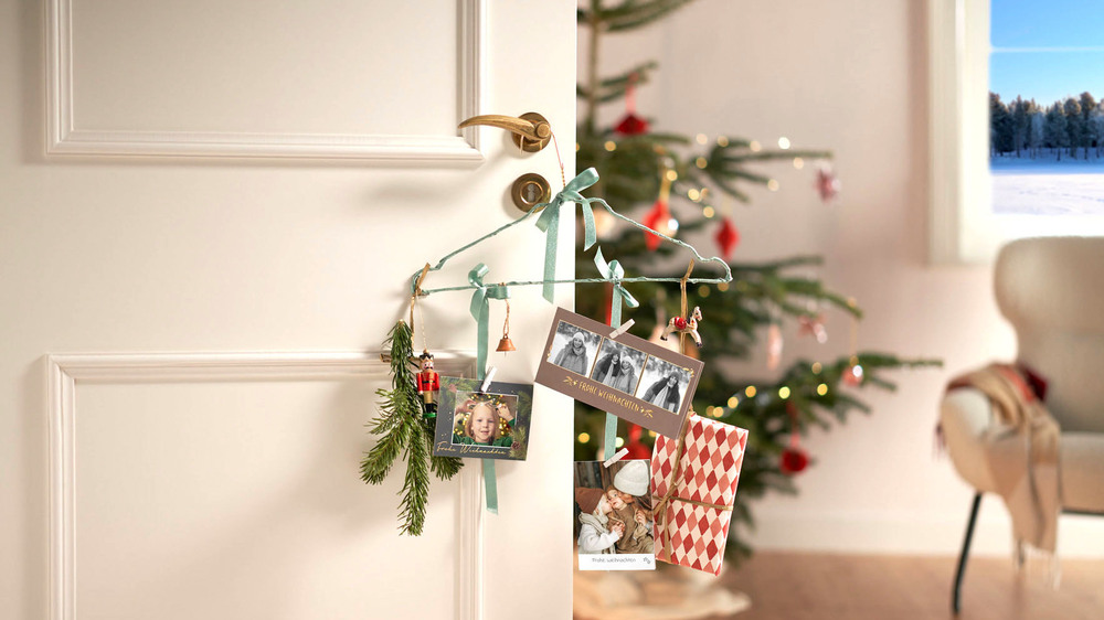 Origineller Blickfang für die Adventszeit: Ein Kleiderbügel wird zur persönlichen Kartengalerie. Foto: DJD/www.cewe.de