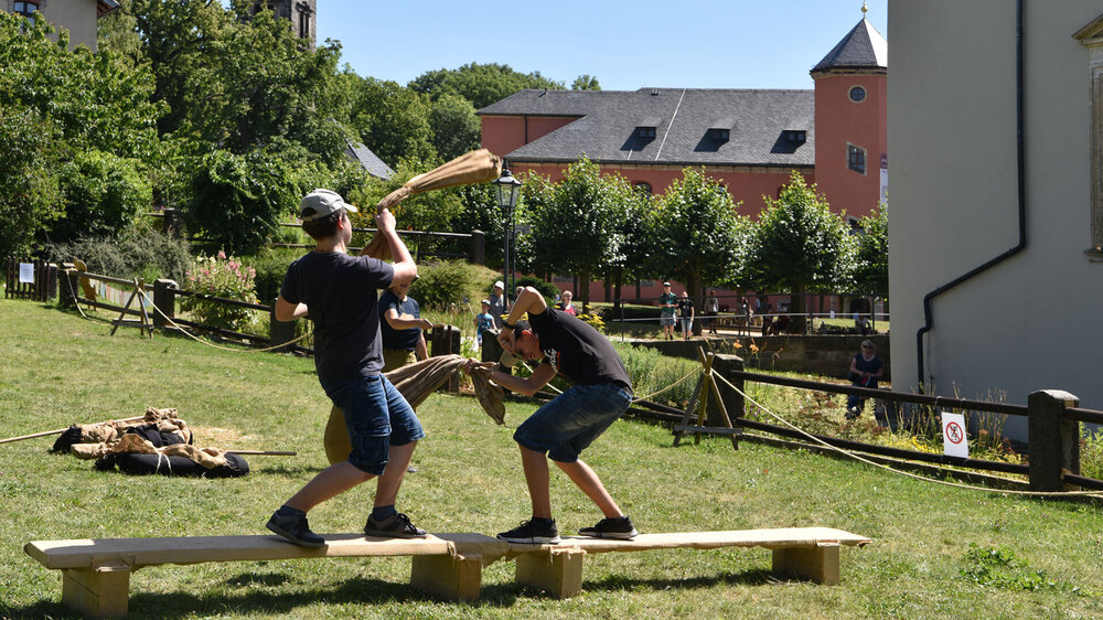 Spielen wir vor 100 Jahren: Wer behält beim "Sackschlagen" länger die Balance? © Festung Königstein gGmbH